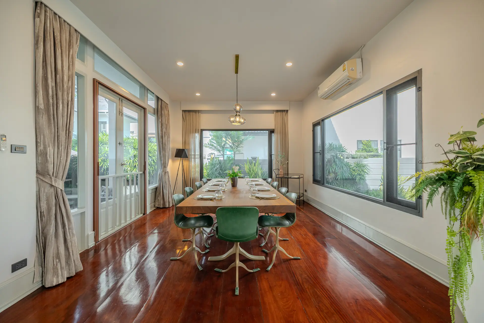 Dining room with a long wooden table at Villa Oasis