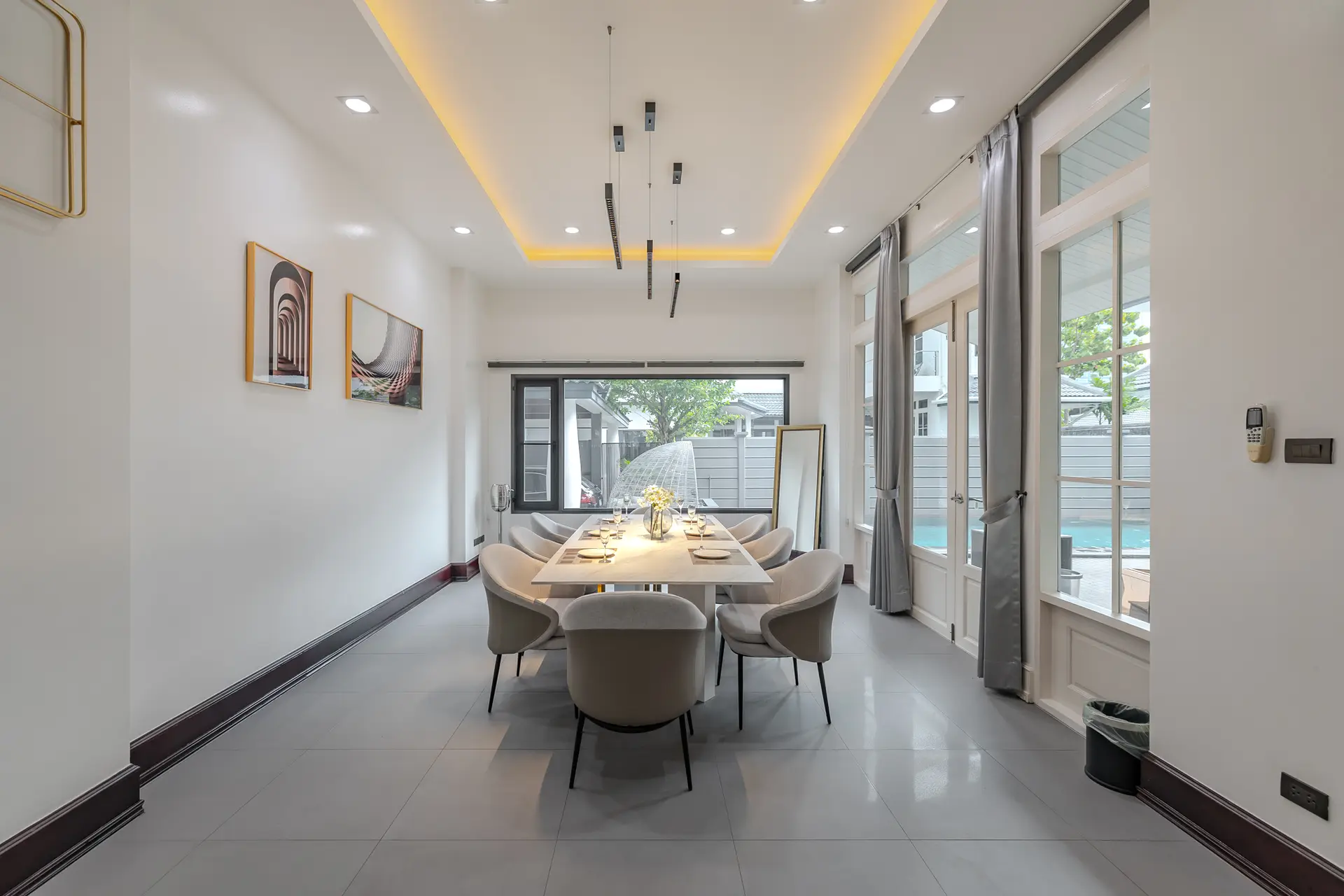Dining room with a long table and a view of the pool at Villa Sol