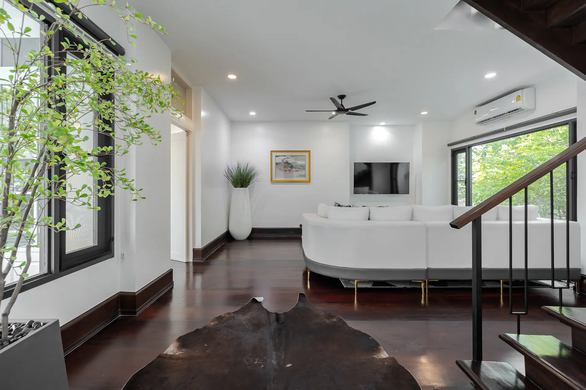 Living room with a white sofa and a staircase at Villa Sol