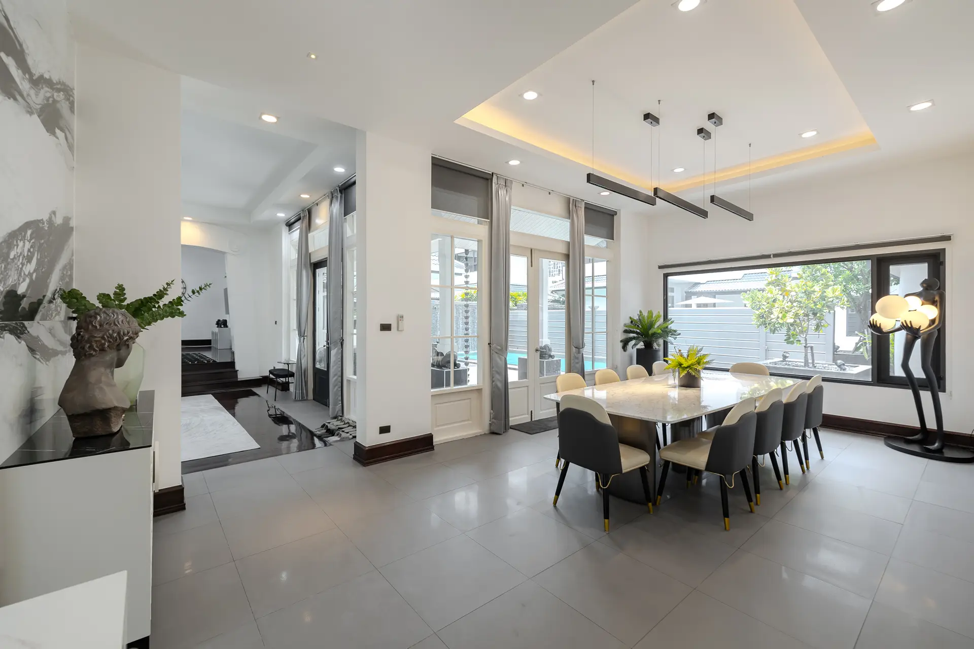 Dining room with a long table and garden window at Villa Noir