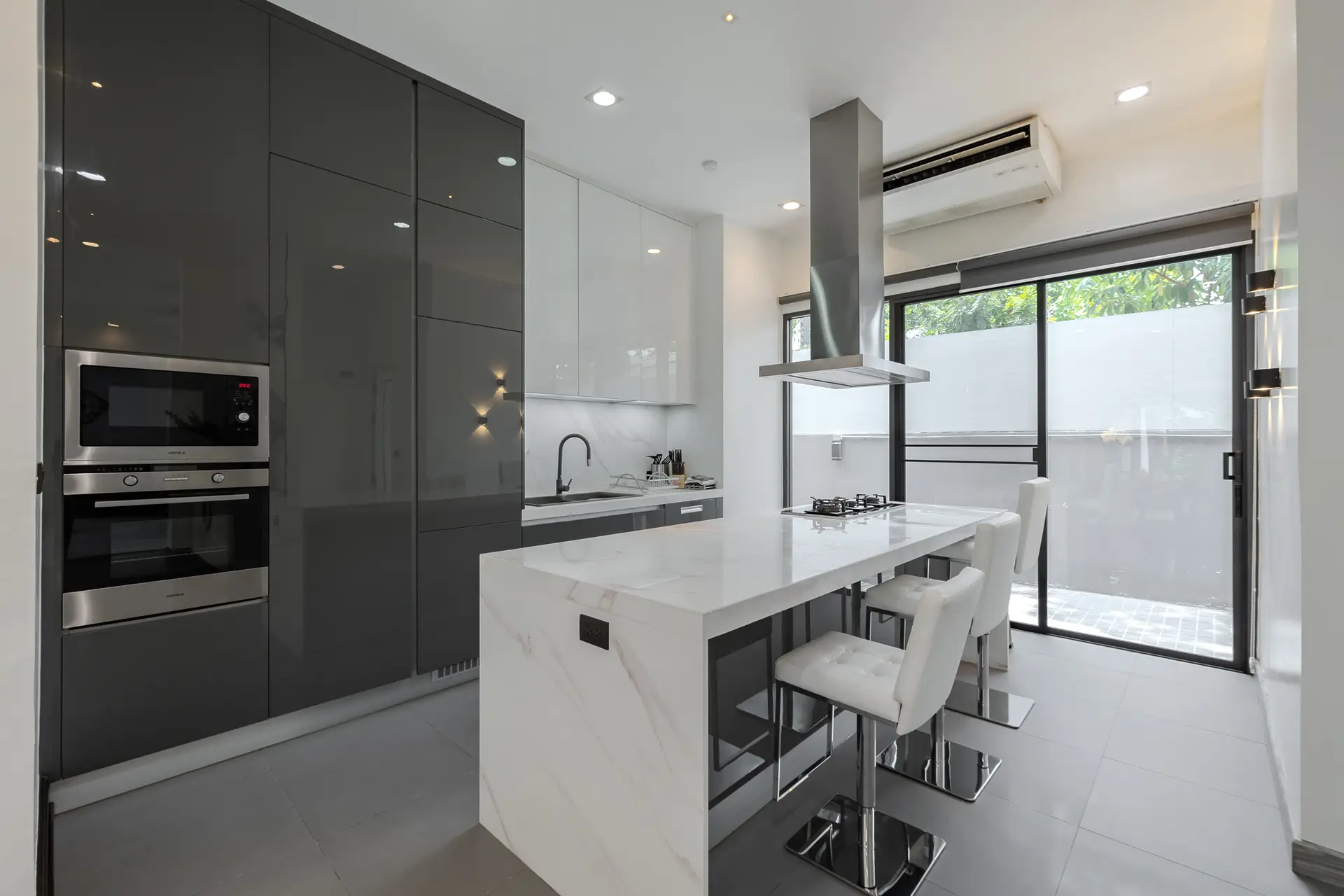 Kitchen with island and built-in appliances at Villa Noir